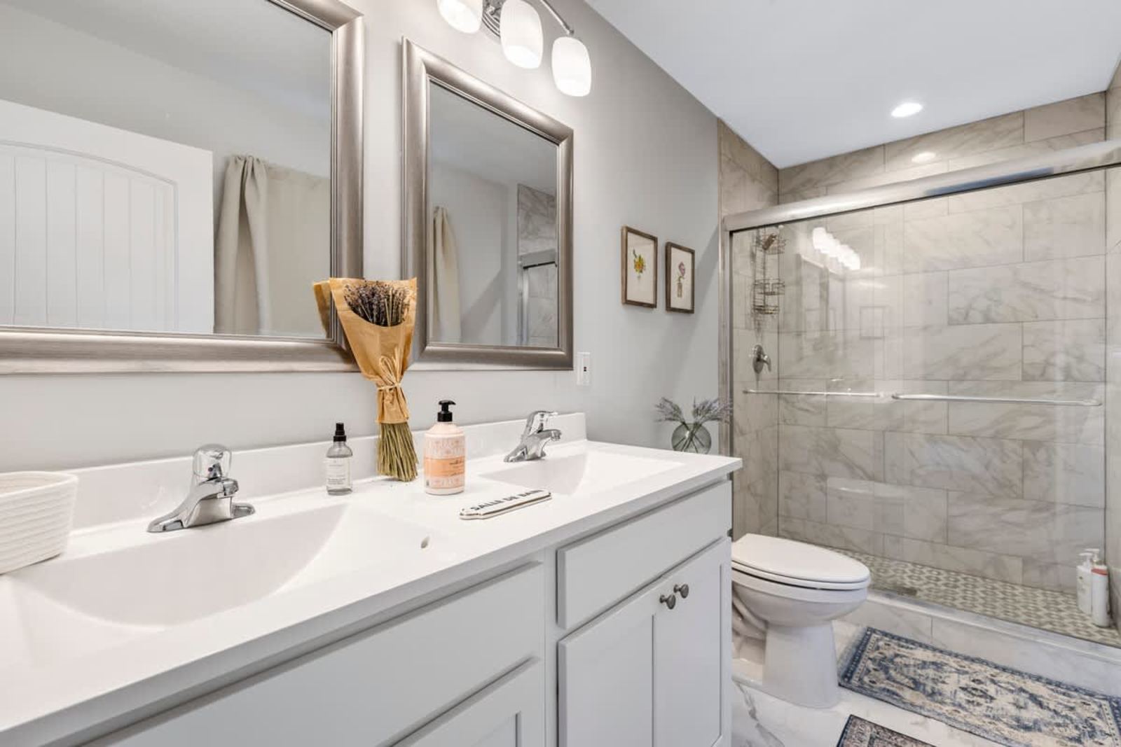 Full bathroom with a double vanity and a walk-in tiled shower