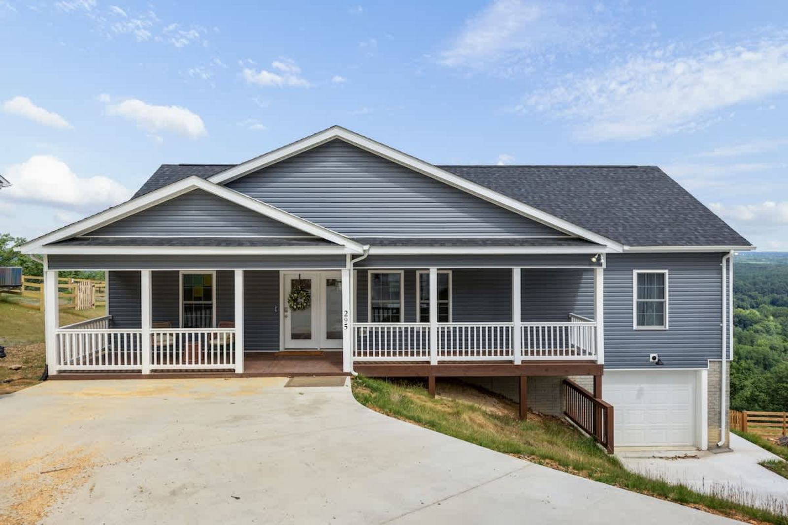 Mountainside ranch home with a covered porch and paved drive