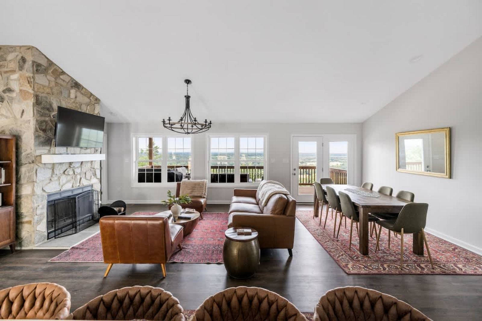 Great room with a stone fireplace and vaulted ceiling