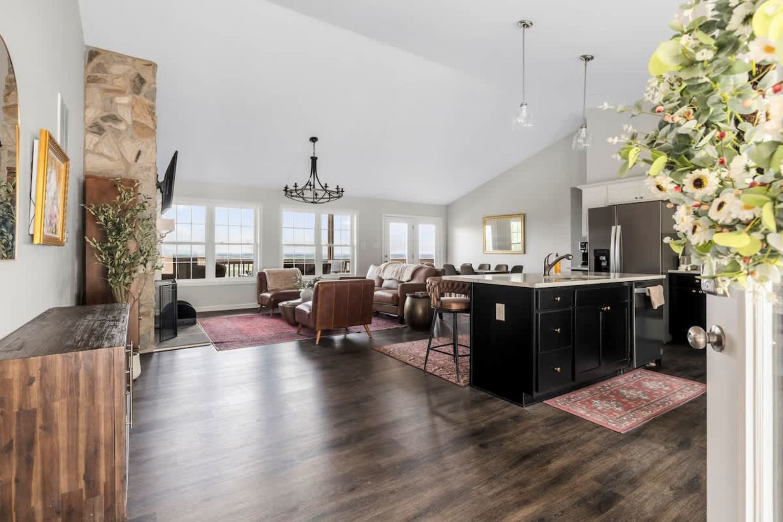 Open-plan kitchen, dining, and living room with a wall of windows