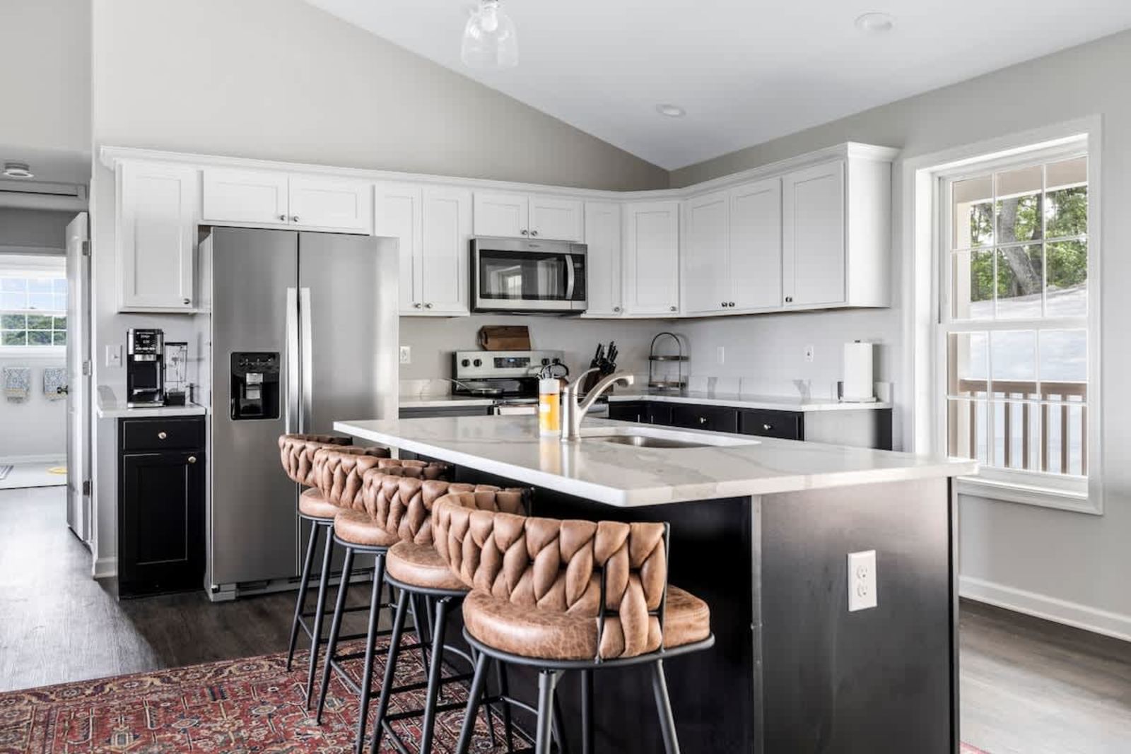 Modern kitchen with an island, leather barstools, and stainless appliances